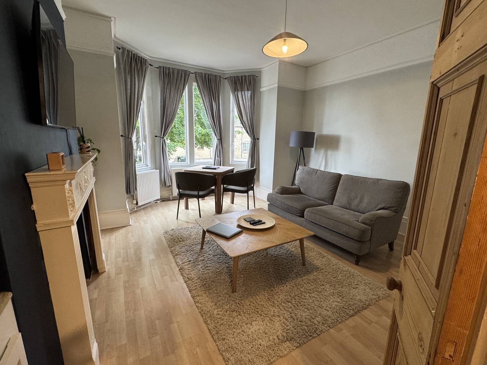 Dining table for two beside the bay window with garden views
