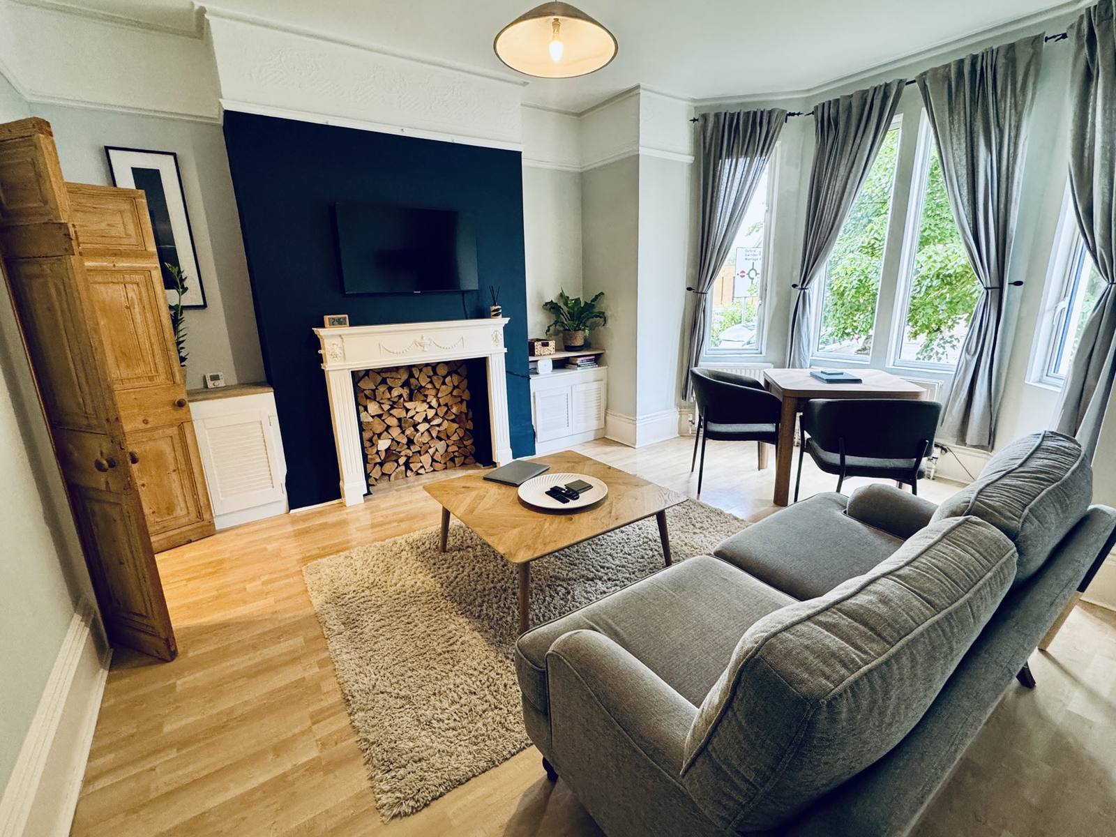 Living room with a comfortable sofa, coffee table and dining area by the bay window